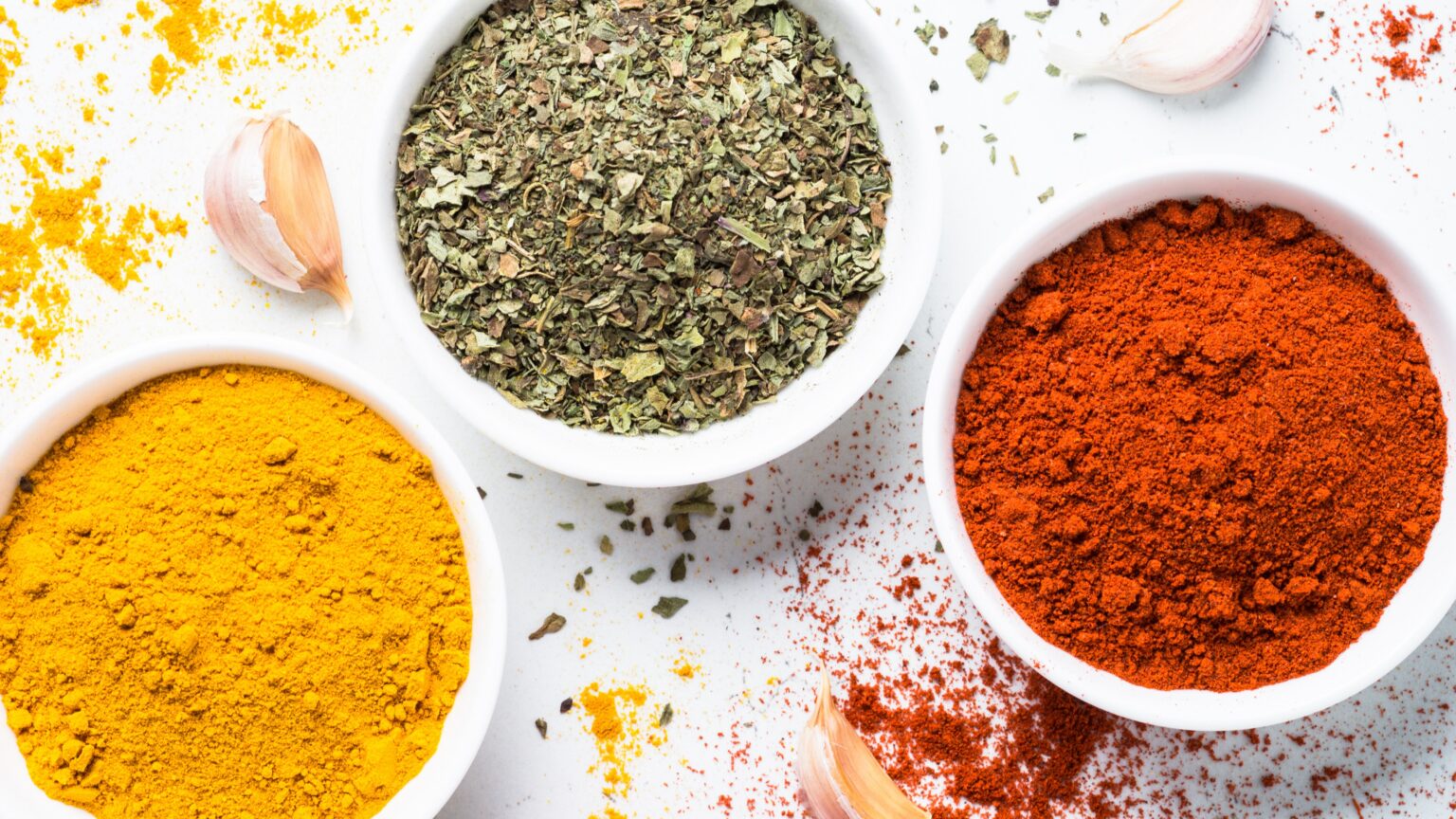 Bowls of ground spices and dried herbs
