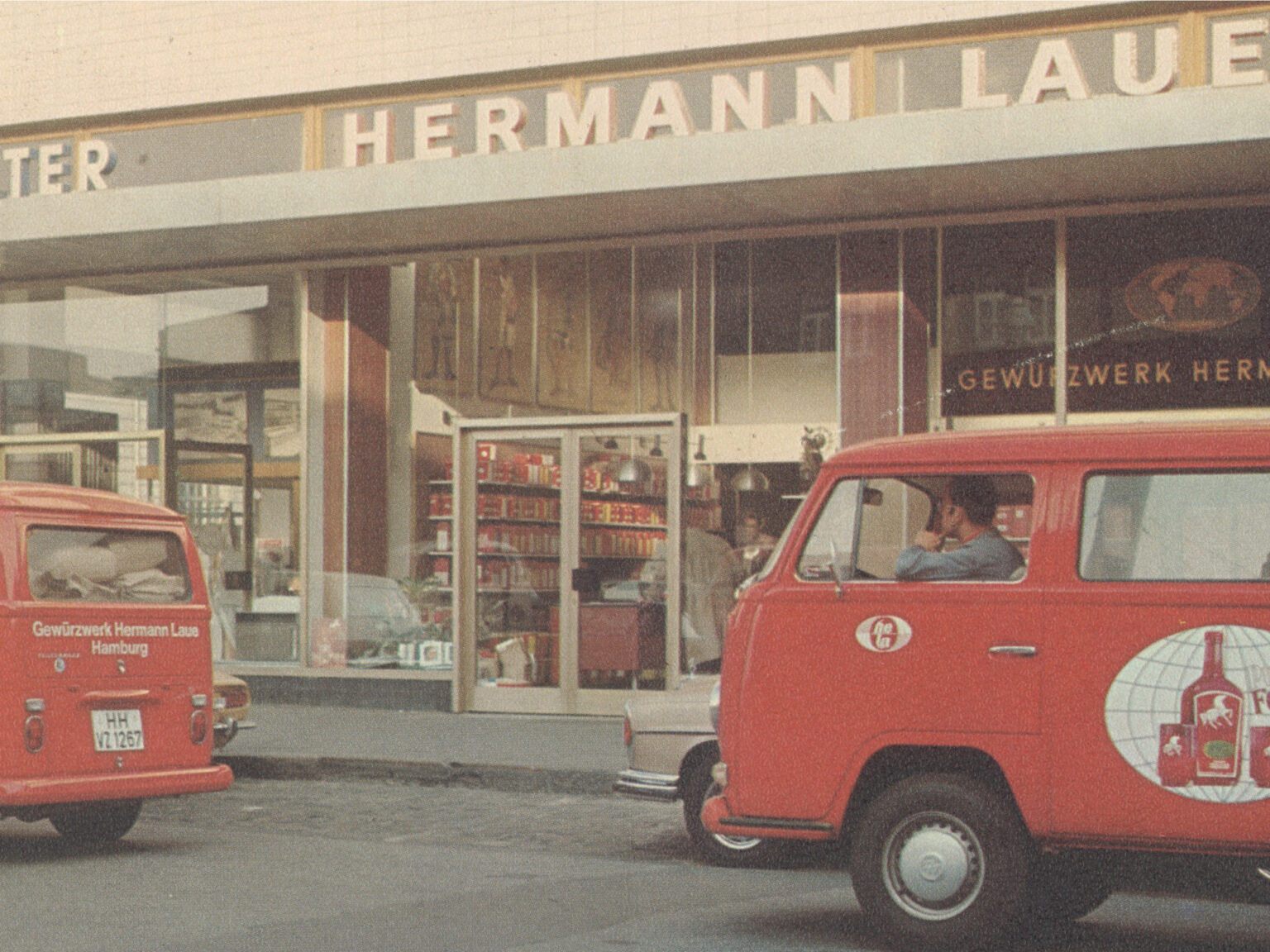 Historic Hermann Laue shopfront and red delivery vans